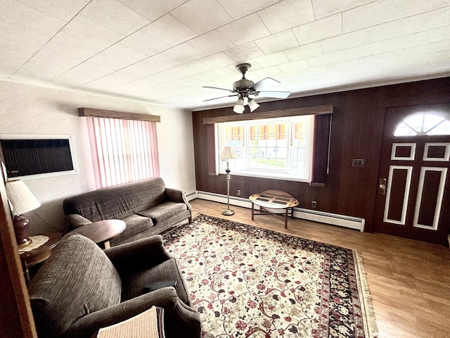 187 Maine Ave, Millinocket, ME 04462 - living room featuring healthy amount of natural light, wood finished floors, ceiling fan, and baseboard heating
