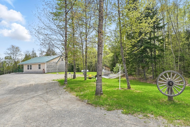 30 Bassett Ln, Moscow, ME 04920 - view of front facade featuring dirt driveway, metal roof, and a front yard