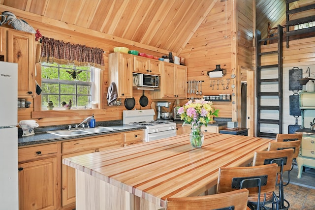30 Bassett Ln, Moscow, ME 04920 - kitchen with white appliances, vaulted ceiling, a sink, wooden walls, and wooden ceiling