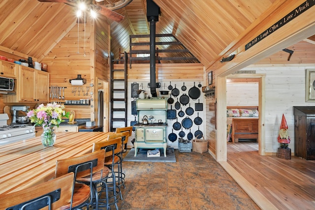 30 Bassett Ln, Moscow, ME 04920 - dining area featuring wooden walls, a ceiling fan, high vaulted ceiling, and wood ceiling