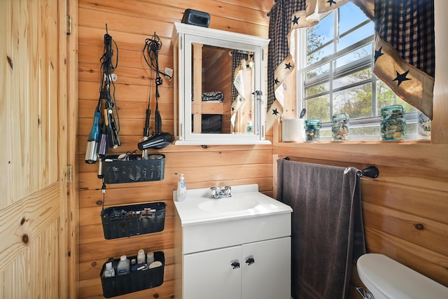30 Bassett Ln, Moscow, ME 04920 - bathroom with wood walls, toilet, and vanity