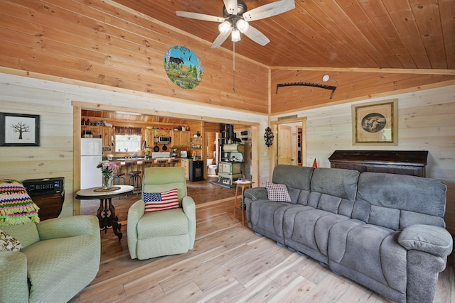 30 Bassett Ln, Moscow, ME 04920 - living room featuring wooden walls, wood ceiling, high vaulted ceiling, ceiling fan, and light wood-style flooring