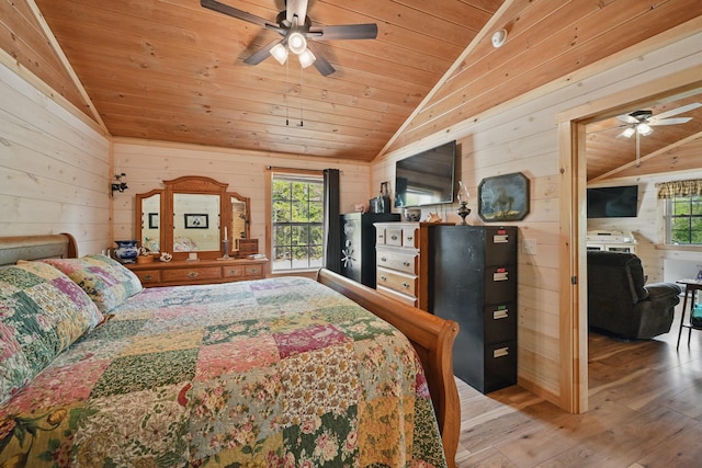 30 Bassett Ln, Moscow, ME 04920 - bedroom with vaulted ceiling, light wood finished floors, wood walls, and wooden ceiling