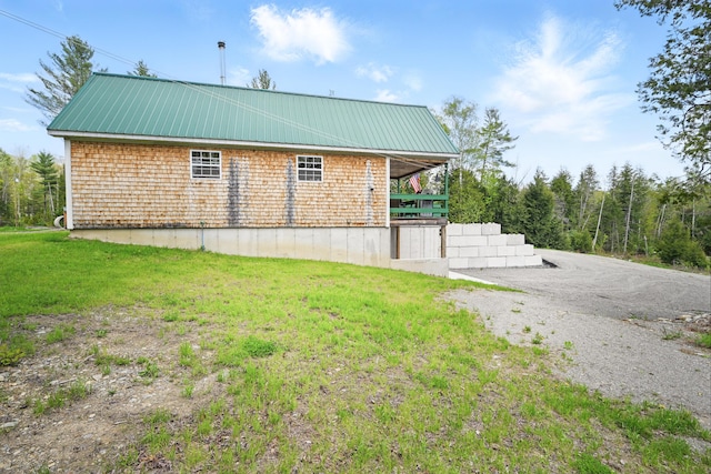 30 Bassett Ln, Moscow, ME 04920 - view of side of home with a lawn and metal roof