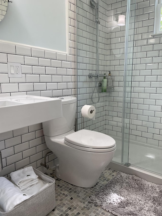 67 Pascal Ave, Rockport, ME 04856 - bathroom with tile walls, a shower stall, toilet, tile patterned flooring, and a wainscoted wall
