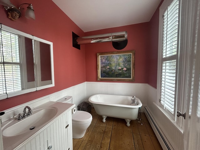 67 Pascal Ave, Rockport, ME 04856 - bathroom with a wainscoted wall, a soaking tub, healthy amount of natural light, toilet, and wood-type flooring