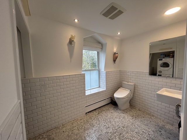 67 Pascal Ave, Rockport, ME 04856 - half bath with a baseboard radiator, tile walls, a wainscoted wall, toilet, and recessed lighting