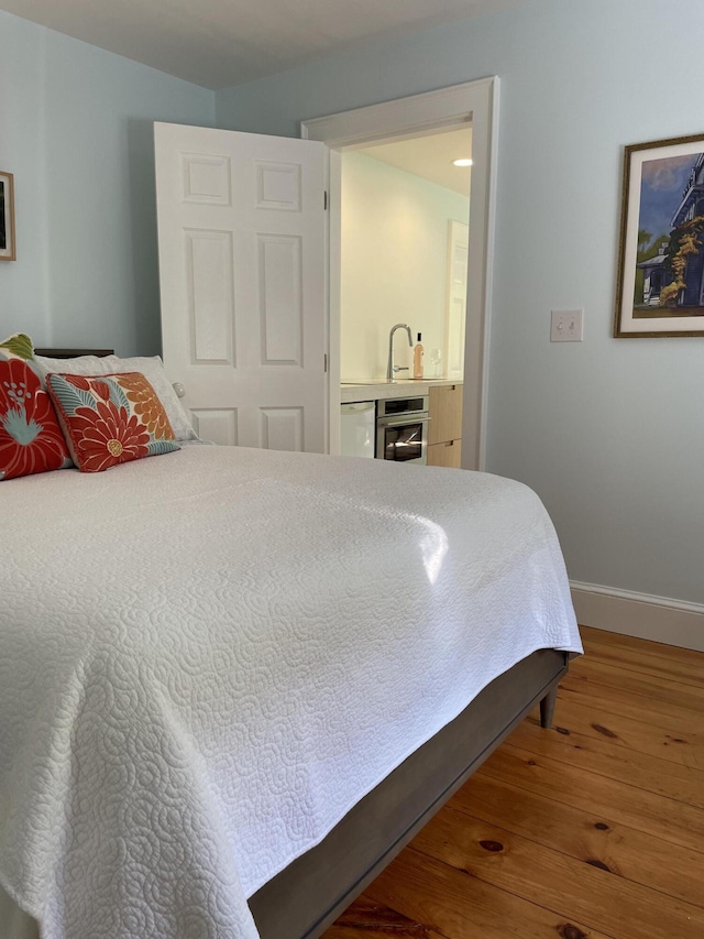 67 Pascal Ave, Rockport, ME 04856 - bedroom with wood finished floors, baseboards, and wet bar