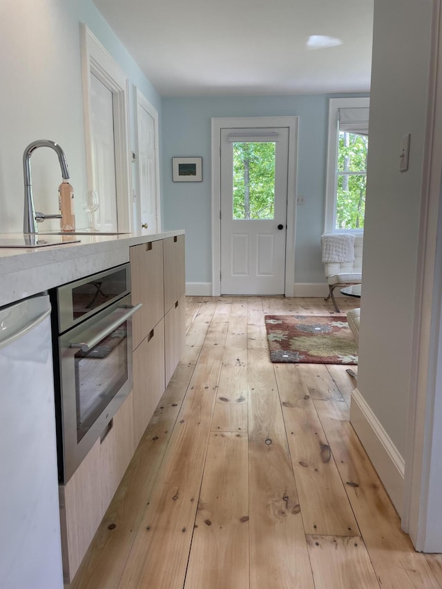 67 Pascal Ave, Rockport, ME 04856 - doorway featuring light wood-style flooring, baseboards, and a sink