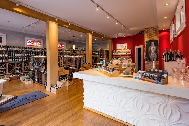 67 Pascal Ave, Rockport, ME 04856 - indoor dry bar featuring rail lighting, wood finished floors, recessed lighting, and ornate columns