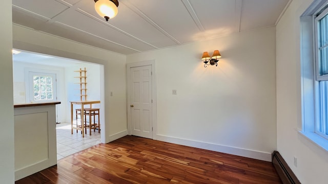 103 Water St, Machias, ME 04654 - spare room featuring baseboard heating, wood finished floors, and baseboards