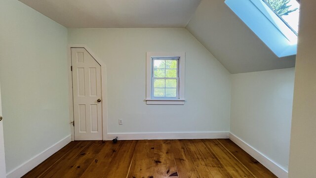 103 Water St, Machias, ME 04654 - additional living space with hardwood / wood-style flooring, a skylight, vaulted ceiling, and baseboards