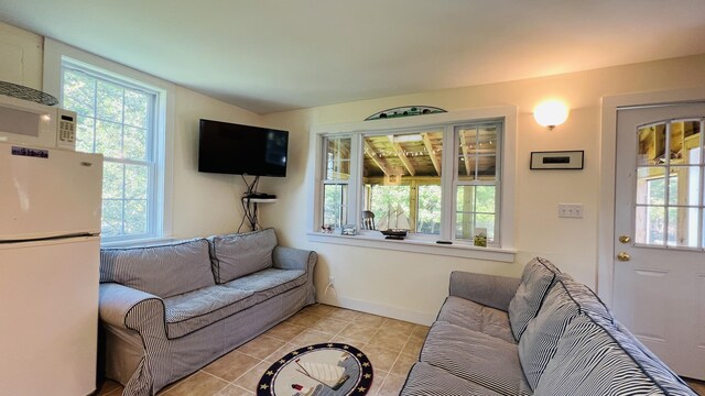 103 Water St, Machias, ME 04654 - living area with light tile patterned flooring, healthy amount of natural light, and baseboards