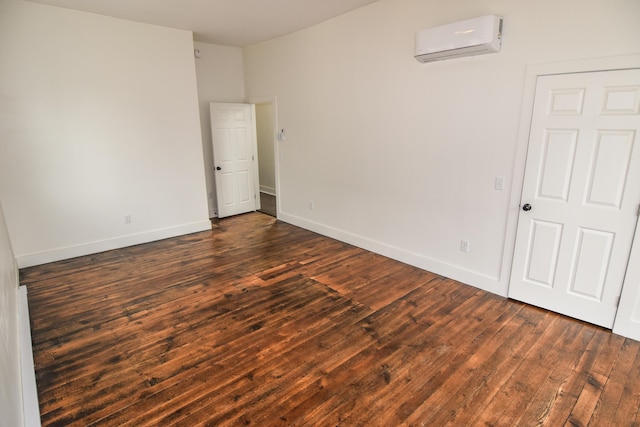 33 Main St, Cornish, ME 04020 - empty room with a wall mounted AC, dark wood-style floors, and baseboards