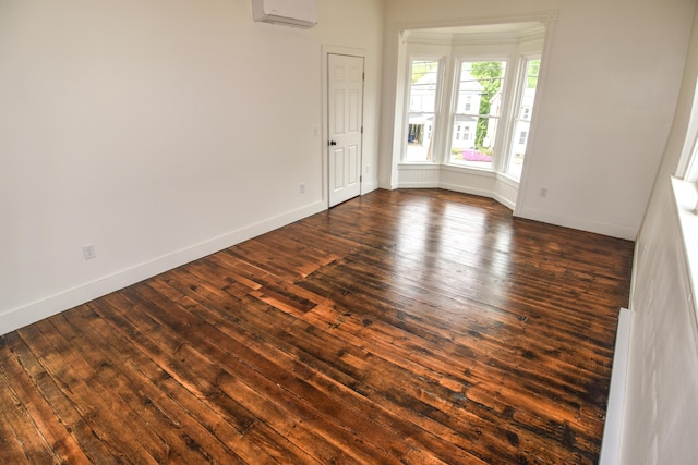 33 Main St, Cornish, ME 04020 - empty room featuring an AC wall unit, baseboards, and dark wood-style floors