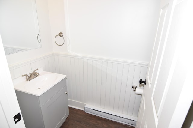 33 Main St, Cornish, ME 04020 - bathroom featuring a baseboard radiator, vanity, wainscoting, and wood finished floors