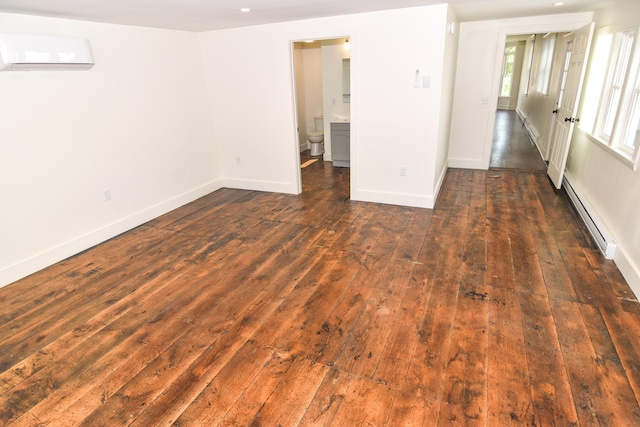 33 Main St, Cornish, ME 04020 - empty room with a baseboard heating unit, a wall mounted AC, dark wood-style flooring, and baseboards