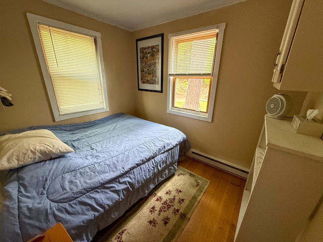 3 Trout Ln, Brownfield, ME 04010 - bedroom with baseboard heating, wood finished floors, ornamental molding, and baseboards