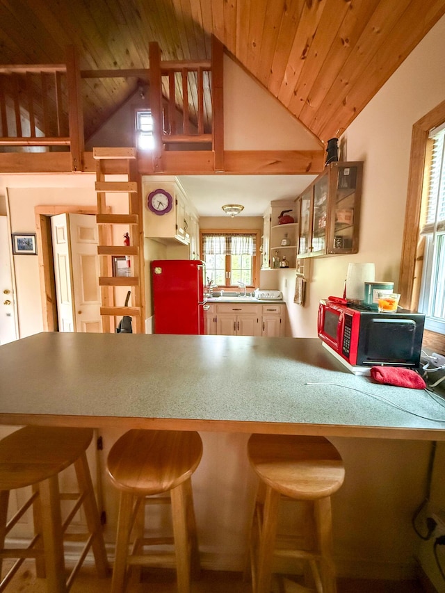 3 Trout Ln, Brownfield, ME 04010 - kitchen featuring high vaulted ceiling, open shelves, a peninsula, a sink, and a kitchen breakfast bar