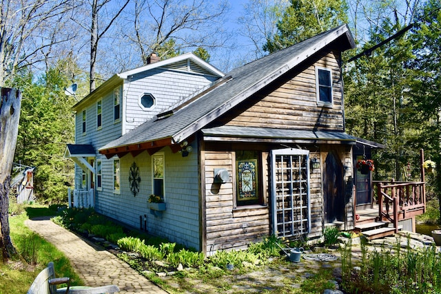 217 Jackson Rd, Monroe, ME 04951 - view of home's exterior with roof with shingles, a chimney, and a wooden deck