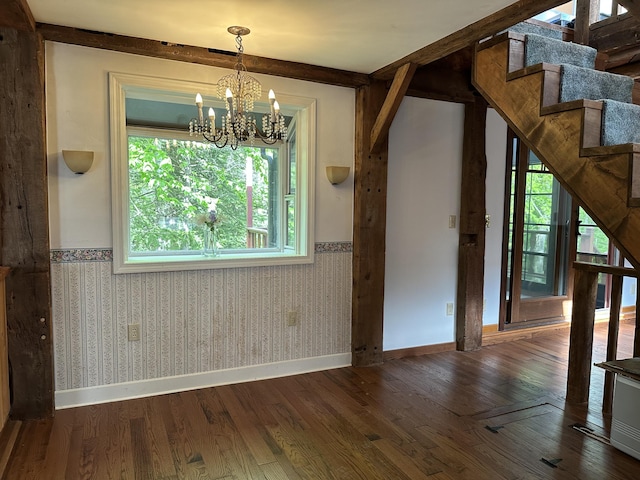 217 Jackson Rd, Monroe, ME 04951 - unfurnished dining area with stairs, a wainscoted wall, wood finished floors, a chandelier, and baseboards