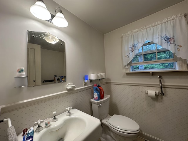 217 Jackson Rd, Monroe, ME 04951 - half bath featuring toilet, a wainscoted wall, and a sink