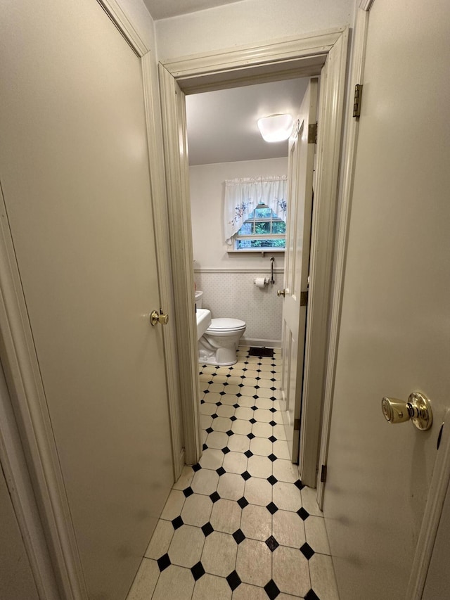 217 Jackson Rd, Monroe, ME 04951 - bathroom with tile patterned floors, toilet, wainscoting, and tile walls