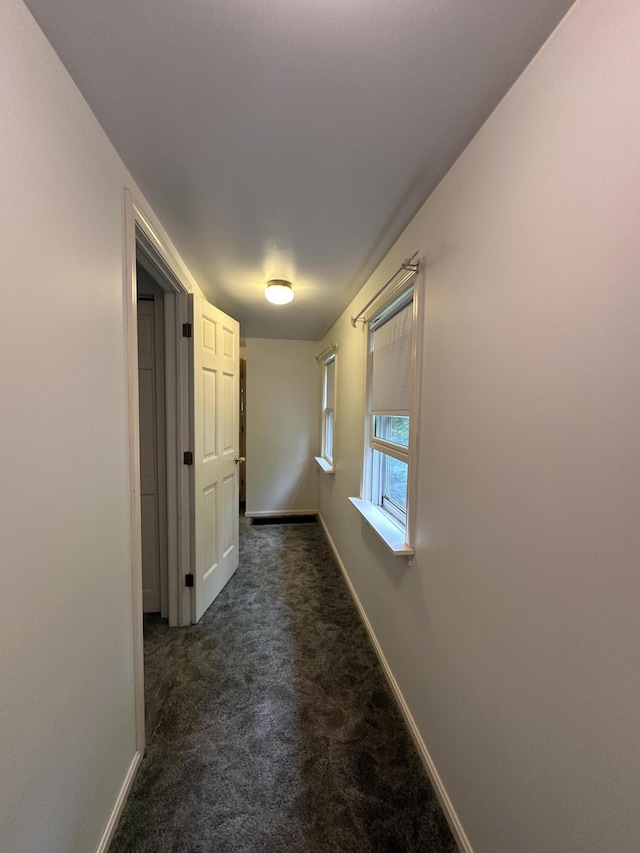 217 Jackson Rd, Monroe, ME 04951 - hall featuring dark colored carpet and baseboards