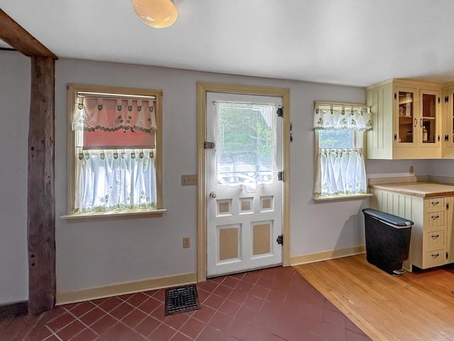 217 Jackson Rd, Monroe, ME 04951 - doorway to outside with baseboards and dark tile patterned floors