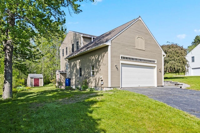 43 W Lynne Ave, Portland, ME 04103 - view of side of property with a garage, a shed, a lawn, and asphalt driveway
