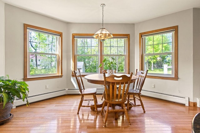 43 W Lynne Ave, Portland, ME 04103 - dining room featuring a chandelier, a baseboard heating unit, and healthy amount of natural light