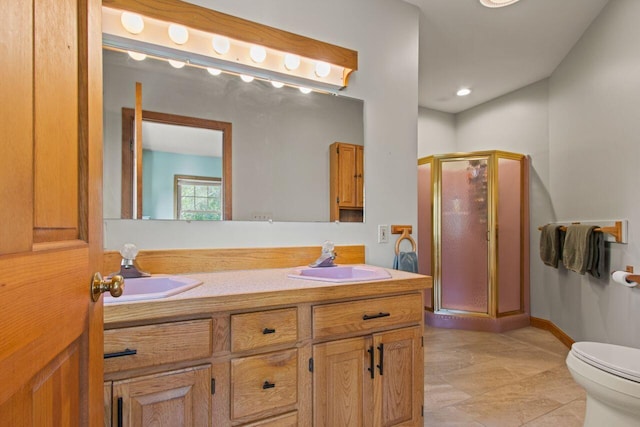 43 W Lynne Ave, Portland, ME 04103 - bathroom featuring a shower stall, toilet, double vanity, and baseboards