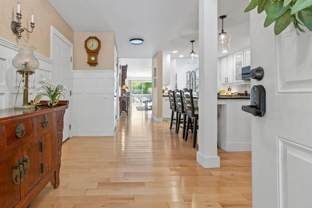 12 Kimberly Ct Unit 1, Portland, ME 04103 - hall featuring light wood-style flooring, a decorative wall, and wainscoting