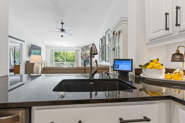 12 Kimberly Ct Unit 1, Portland, ME 04103 - kitchen with tasteful backsplash, ceiling fan, dark stone counters, white cabinetry, and open floor plan