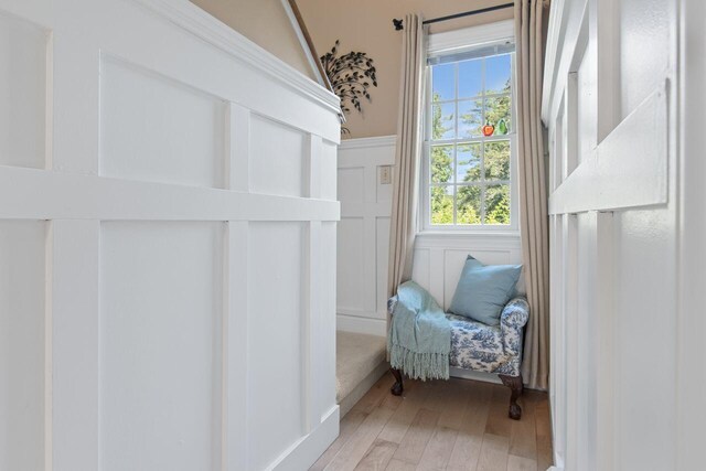 12 Kimberly Ct Unit 1, Portland, ME 04103 - sitting room featuring light wood-style flooring, a decorative wall, and wainscoting