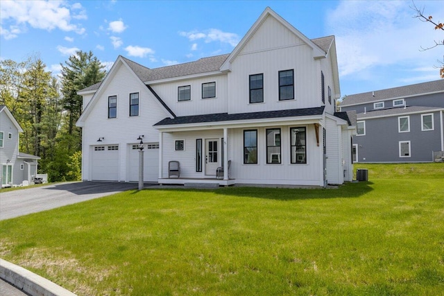 5 Cobblestone St Unit 53, Falmouth, ME 04105 - view of front facade featuring board and batten siding, a porch, a garage, driveway, and a front yard