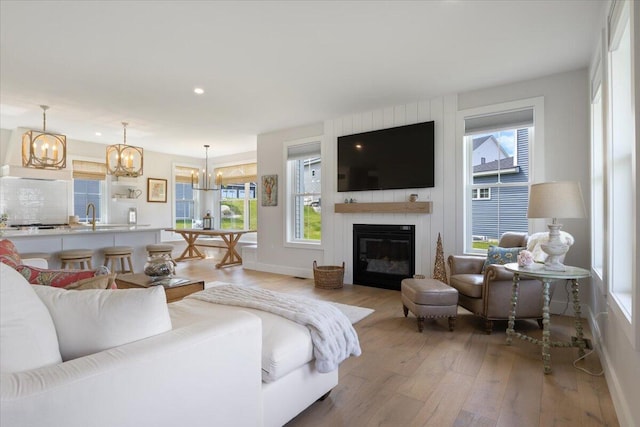5 Cobblestone St Unit 53, Falmouth, ME 04105 - living area with a chandelier, light wood-style floors, recessed lighting, a glass covered fireplace, and baseboards