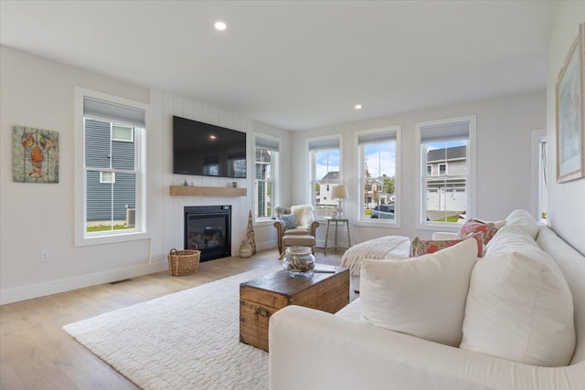 5 Cobblestone St Unit 53, Falmouth, ME 04105 - living area featuring a fireplace, wood finished floors, baseboards, and recessed lighting