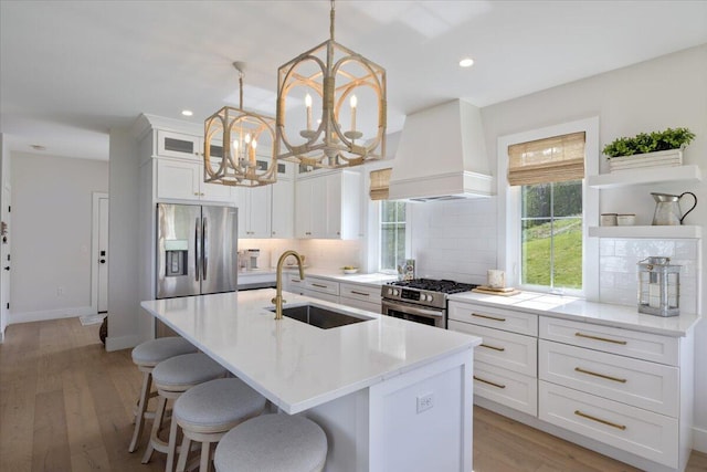 5 Cobblestone St Unit 53, Falmouth, ME 04105 - kitchen with a sink, appliances with stainless steel finishes, premium range hood, a kitchen island with sink, and decorative backsplash