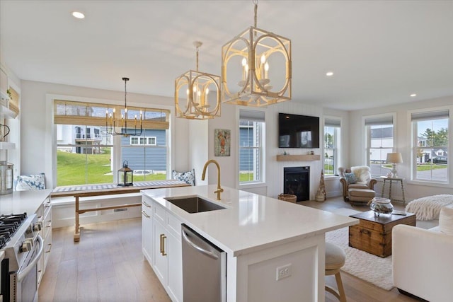 5 Cobblestone St Unit 53, Falmouth, ME 04105 - kitchen with a sink, stainless steel appliances, a chandelier, open floor plan, and light wood-type flooring