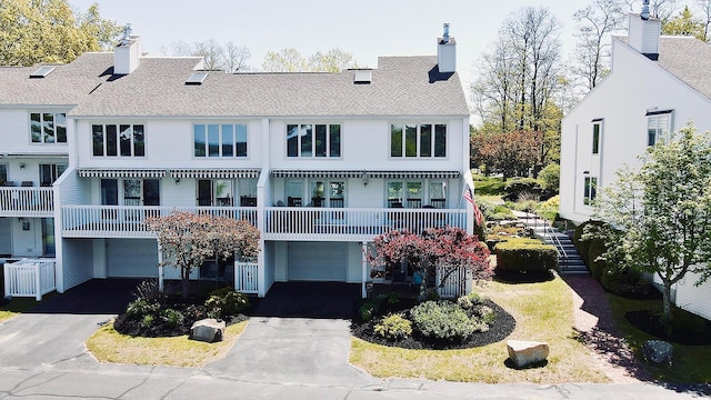 7 Goodridge Dr Unit 7, Naples, ME 04055 - back of property featuring an attached garage, driveway, and a chimney