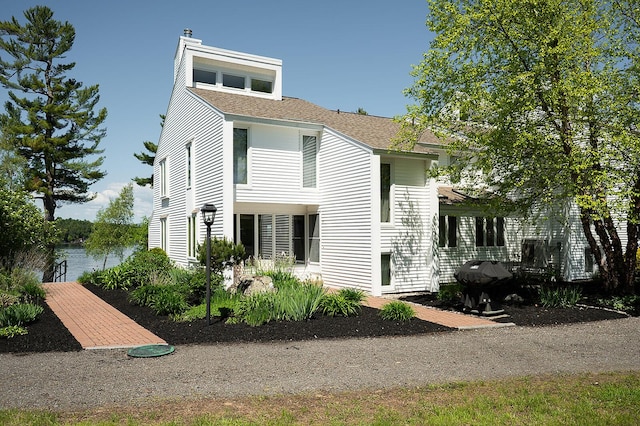 7 Goodridge Dr Unit 7, Naples, ME 04055 - view of front of home featuring a shingled roof and a chimney