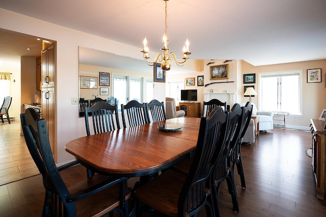 7 Goodridge Dr Unit 7, Naples, ME 04055 - dining room featuring a chandelier, dark wood finished floors, healthy amount of natural light, and baseboards