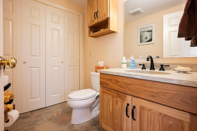 7 Goodridge Dr Unit 7, Naples, ME 04055 - bathroom with vanity, stone tile floors, and toilet
