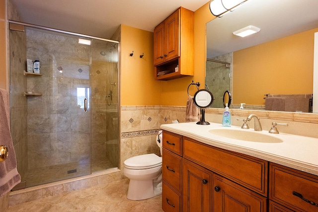 7 Goodridge Dr Unit 7, Naples, ME 04055 - full bathroom featuring toilet, vanity, a shower stall, a wainscoted wall, and tile patterned floors