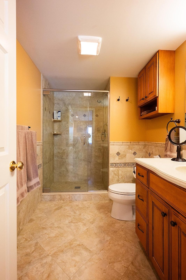 7 Goodridge Dr Unit 7, Naples, ME 04055 - full bathroom with vanity, a shower stall, toilet, a wainscoted wall, and tile walls
