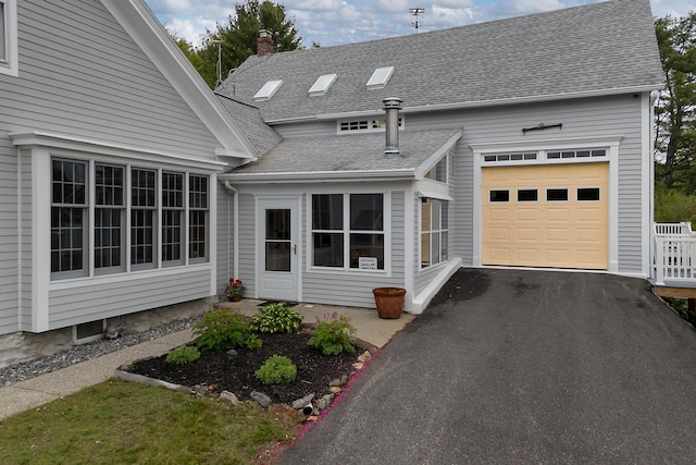 96 Grove St, Lewiston, ME 04240 - view of front of property with roof with shingles, asphalt driveway, a garage, and a chimney