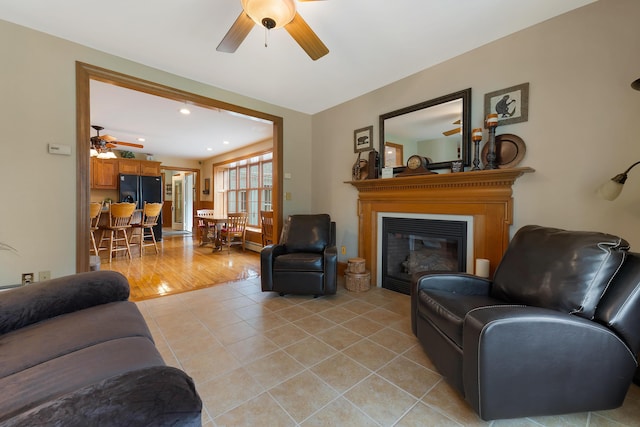 96 Grove St, Lewiston, ME 04240 - living area with a ceiling fan, light tile patterned floors, a glass covered fireplace, and recessed lighting