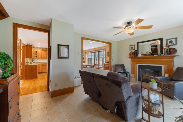 96 Grove St, Lewiston, ME 04240 - living room with a ceiling fan, light tile patterned flooring, a glass covered fireplace, recessed lighting, and baseboards