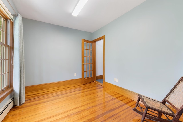 96 Grove St, Lewiston, ME 04240 - unfurnished room featuring a baseboard radiator, light wood-type flooring, and baseboards